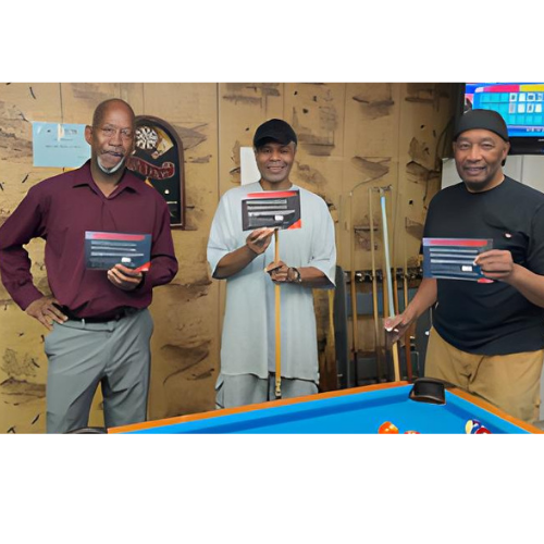 3 men playing pool
